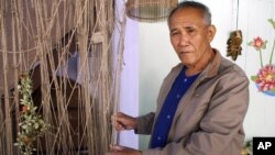 Boonrian Chinnarat holds a net he once used to catch giant catfish at his house in Chiang Kong district of Chiang Rai province, northern Thailand, Feb. 7, 2011. He blames the disappearance of the fish partly on China's upstream dams.