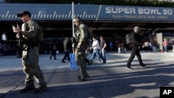 Members of the FBI SWAT team keep watch inside the NFL Experience, Feb. 2, 2016, in San Francisco. 