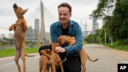 Director Diego Freitas plays with caramelo dogs on the set of the Netflix film 'Caramelo' in Sao Paulo, Oct. 29, 2024. 