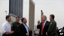 President Donald Trump reviews border wall prototypes, March 13, 2018, in San Diego.