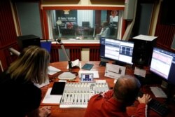 Employees of the opposition radio-station Klubradio work at its headquarters in Budapest, Hungary, Feb. 9, 2021.