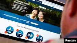 FILE - A man looks over the Affordable Care Act (commonly known as Obamacare) signup page on the HealthCare.gov website in New York in this photo illustration. 