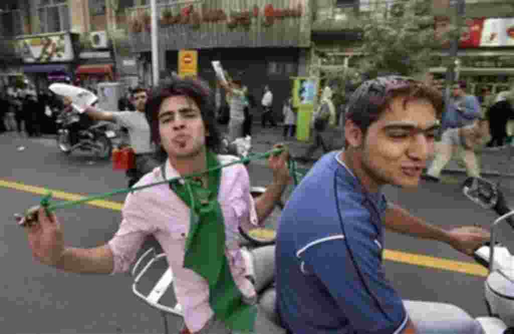 Young supporters of reformist candidate Mir Hossein Mousavi speed up and down Valiasr street on motorcycles in celebratory mood in downtown Tehran, Iran, Monday, June 8, 2009. At a massive pro-Mousavi street rally in Tehran, supporters decked out in green
