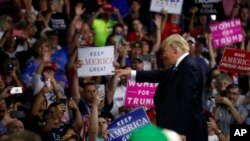 President Donald Trump points to a supporter after speaking during a rally Tuesday, Aug. 21, 2018, in Charleston, W.Va.