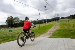 Pengendara sepeda gunung menggunakan lift sepeda di area Wexl Trails, St. Corona am Wechsel, Lower Austria pada 23 Juli 2021.