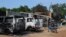 FILE - Burnt vehicles and houses are pictured on a street, after Boko Haram militants raided the town of Benisheik, west of Borno State capital Maiduguri.