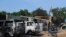 FILE - Burnt vehicles and houses are pictured on a street, after Boko Haram militants raided the town of Benisheik, west of Borno State capital Maiduguri.