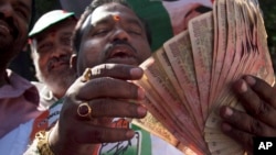بھارت کی حکومت مخالف کانگریس پارٹی کا ایک کارکن ایک ہزار روپے کے کرنسی نوٹوں کی بندش کے خلاف احتجاج کر رہا ہے۔ نومبر 2016