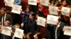 Opposition members of the Italian parliament display placards in Italian reading "Meloni where are you?" during a debate in Rome, Feb. 5, 2025, over the controversial repatriation of Libyan warlord Ossama Anjiem, also known as Ossama al-Masri.