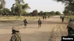 FILE - Nigerien soldiers patrol at the border with Nigeria, March 25, 2015. Nigerian defense officials warned Nov. 7, 2024, that a new insurgent group has infiltrated the country's northwestern region after Niger’s 2023 coup joint disrupted military patrols along the border.