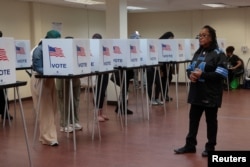 Voters cast their votes during early voting in the U.S. presidential election at a polling station in Detroit, Michigan, Nov. 3, 2024.