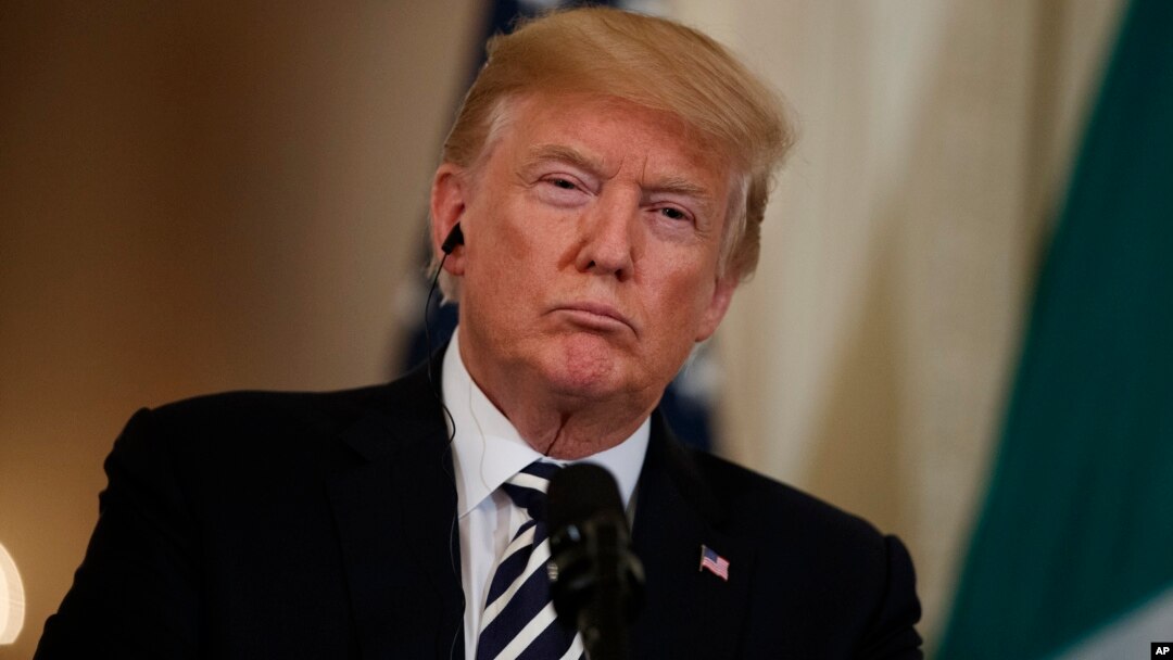 President Donald Trump listens to Italian Prime Minister Giuseppe Conte during a news conference in the East Room of the White House, in Washington, July 30, 2018.