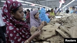 Women work at a garment factory in Savar, Bangladesh, July 27, 2012. 