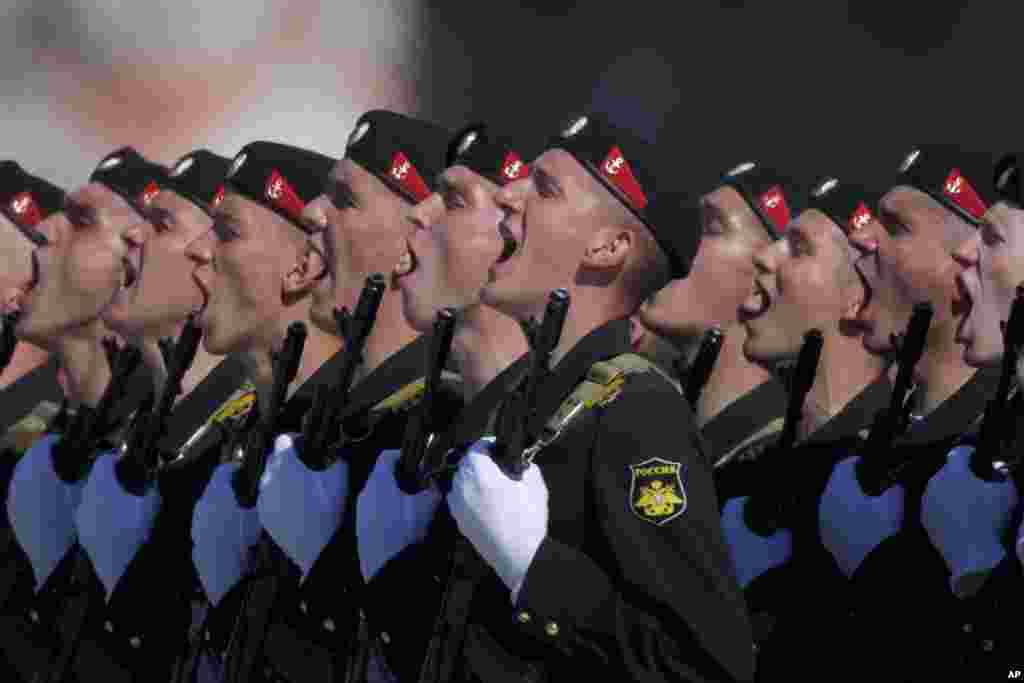 Russian Marines salute as they march along Red Square, Moscow, during a Victory Day parade.