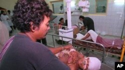 A Phnom Penh resident is treated for wounds at Calmette Hospital he received during a mortar attack in the capital in the late afternoon on Saturday July 5,1997. Fighting broke out between troops loyal to the rival prime ministers and shellfire hit downto