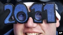 Jeff Singer from Kansas sits in Times Square as he waits for the evening's New Year's Eve celebrations to begin in New York, 31 Dec 2010