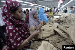 FILE - Women work at a garment factory in Savar, Bangladesh, July 27, 2012.