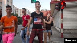 Teenagers walk on the street in Havana, December 21, 2014.