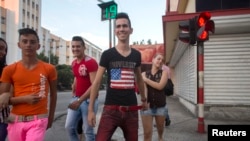 Teenagers walk on the street in Havana.