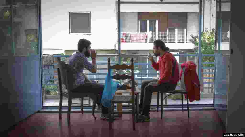 Ali Shokri, right, is a Christian who says he fled Iran because of religious persecution. He is among the volunteers at the Khora center, in the Exarchia district in Athens, Greece, Oct. 24, 2016.