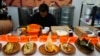 Tamales of different styles are displayed on a table during the tamales fair at the Ixtapalapa neighborhood of Mexico City, Friday, Jan. 27, 2023. (AP Photo/Fernando Llano)