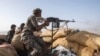 FILE - A Yemeni fighter backed by the Saudi-led coalition fires his weapon during clashes with Houthi rebels near Marib, Yemen, June 20, 2021. Omani mediators arrived in Yemen on Saturday to discuss a new truce between Houthi rebels and Saudi Arabia, a source said.