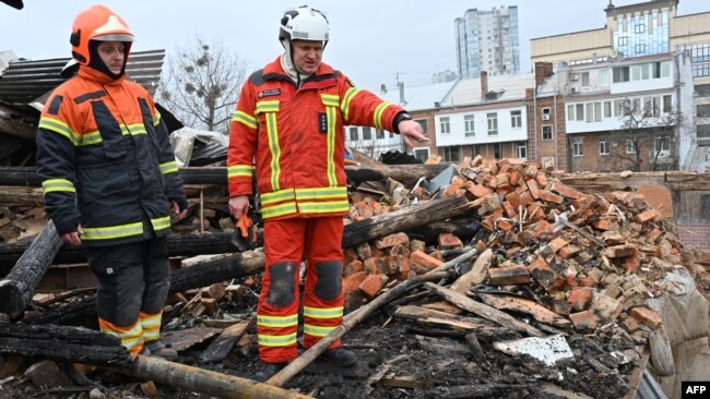 Ukrainian rescuers access at the debris for clearing at a residential building, partially destroyed after a missile strike on Kharkiv on Jan. 30, 2023.