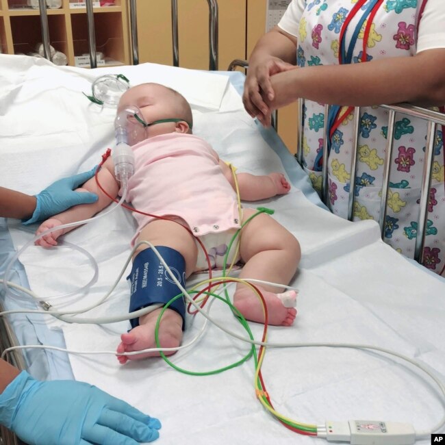 This photo provided by Judy Wei shows her daughter, Rylae-Ann Poulin, the first time she was admitted to an ICU. (Judy Wei via AP)