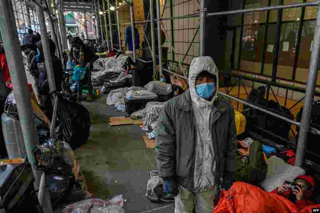 Migrants camp outside a hotel in the Manhattan area of New York as they resist efforts by the city to relocate them to a facility for asylum seekers in Brooklyn, Jan. 31, 2023.