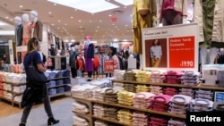 FILE: People shop at a UNIQLO store during the grand opening of the The Hudson Yards development, a residential, commercial, and retail space on Manhattan's West side in New York City. Taken March 15, 2019. 