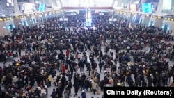 Travelers wait for trains at Hangzhou East railway station during the Spring Festival travel rush ahead of the Chinese Lunar New Year, in Hangzhou, Zhejiang province, China, Jan. 20, 2023.