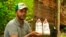 Rubber tapper Rogerio Mendes shows off his Veja sneakers, received as a prize for his work as a young rubber extractor in the Chico Mendes Extractive Reserve, Acre state, Brazil, Dec. 7, 2022. 