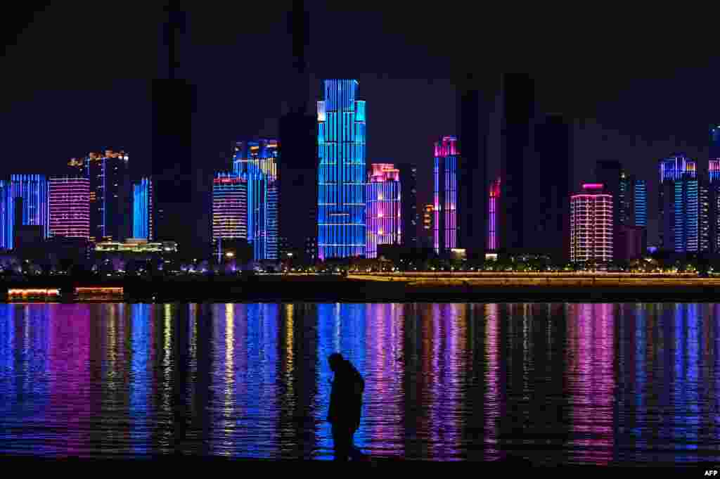 A man walks by the banks of the Yangtze river in Wuhan in China's central Hubei province.