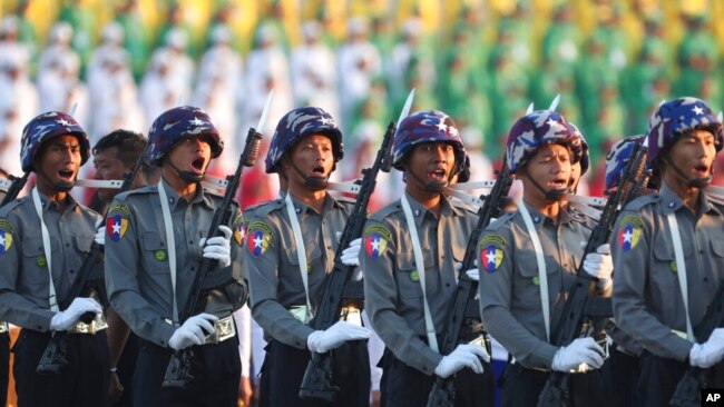 FILE - Police march during a ceremony marking Myanmar's 75th anniversary of Independence Day in Naypyitaw, Myanmar, Jan. 4, 2023.