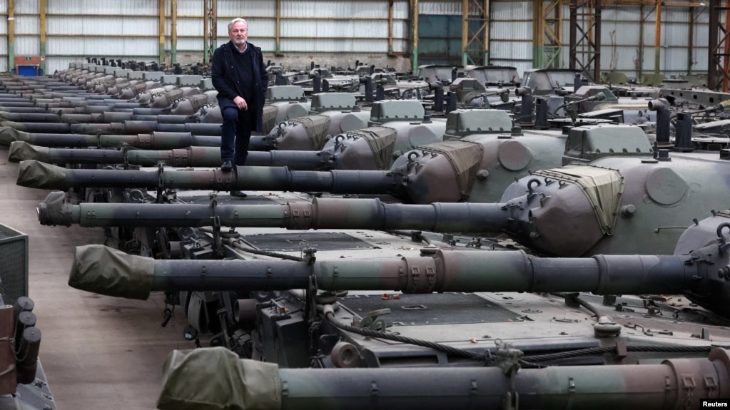 Freddy Versluys, the CEO of Belgian defense company OIP Land Systems, stands among dozens of German-made Leopard 1 tanks, in a hangar in Tournais, Belgium, Jan. 31, 2023.