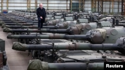 Freddy Versluys, the CEO of Belgian defense company OIP Land Systems, stands among dozens of German-made Leopard 1 tanks, in a hangar in Tournais, Belgium, Jan. 31, 2023.