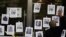 FILE - A man puts up photos of slain journalists after the murder of journalist Fredid Roman during a vigil to protest the crime, outside Mexico's Attorney General's office in Mexico City, Aug. 24, 2022. 