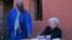 US Treasury Secretary Janet Yellen, flanked by curator Eloi Coly (L), signs the guestbook of the House of Slaves during a visit on Goree Island off the coast of the city of Dakar on January 21, 2023. 