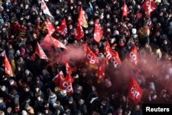 Protesters hold French CGT labor union flags during a demonstration against the French government's pension reform plan in Paris, France, Jan. 31, 2023.