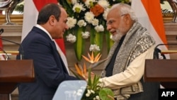 FILE: Egypt's President Abdel Fattah al-Sisi (L) shakes hands with India's Prime Minister Narendra Modi after their joint media briefing at the Hyderabad House in New Delhi on January 25, 2023. 