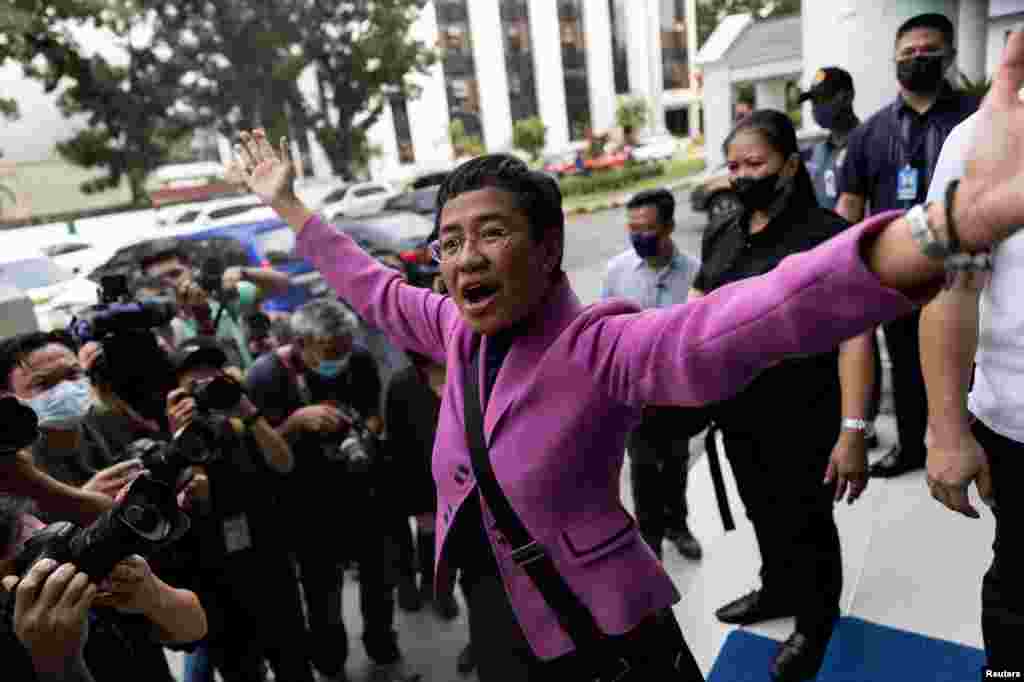 Rappler CEO and Nobel Laureate Maria Ressa gestures after a Manila court acquitted her in a tax evasion case, outside the Court of Tax Appeals in Quezon City, Philippines.
