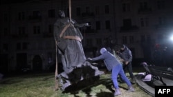 FILE - Workers dismantle a statue of Russian Empress Catherine the Great in the center of Odesa, southern Ukraine on Dec. 29, 2022.