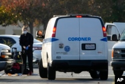 A forensic lab investigator takes her gloves off as the body of Huu Can Tran is retrieved from a van by the Los Angeles County coroner in Torrance, California, Jan. 22, 2023.