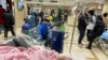 FILE - A patient lies on a bed at the emergency department of a hospital during the COVID-19 outbreak in Shanghai, China, Jan. 17, 2023. Some say China's zero-COVID policy widened the gap in the rural health system.