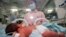 FILE - A nurse takes care of a newborn baby at a hospital in Taizhou in China's eastern Zhejiang province on May 12, 2022.