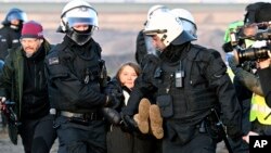 Police officers carry Swedish climate activist Greta Thunberg away from the edge of the Garzweiler II opencast lignite mine during a protest by climate activists after the clearance of Luetzerath, Germany, Jan. 17, 2023. 