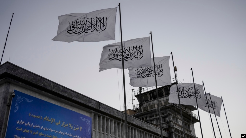 FILE - Taliban flags fly at the airport in Kabul, Afghanistan, Sept. 9, 2021. 