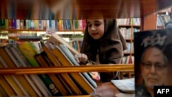 A school student browses through books inside the Darra Adam Khel Library in Darra Adamkhel town, south of Peshawar, Pakistan, Dec. 14, 2022.
