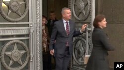 In this handout photo taken from video released by Russian Foreign Ministry Press Service, Estonian Ambassador to the Russian Federation Margus Laidre leaves the Russian Foreign Ministry's building in Moscow, Jan. 23, 2023. 