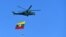 A Myanmar military helicopter carries the national flag over a parade ground to mark the country's Independence Day in Naypyidaw on Jan. 4, 2023.